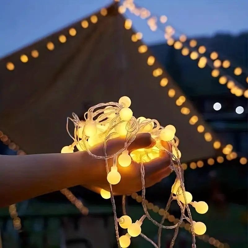 Fairylight lights draped over a tent, enhancing the ambiance of tent, camp, and glamp rentals.